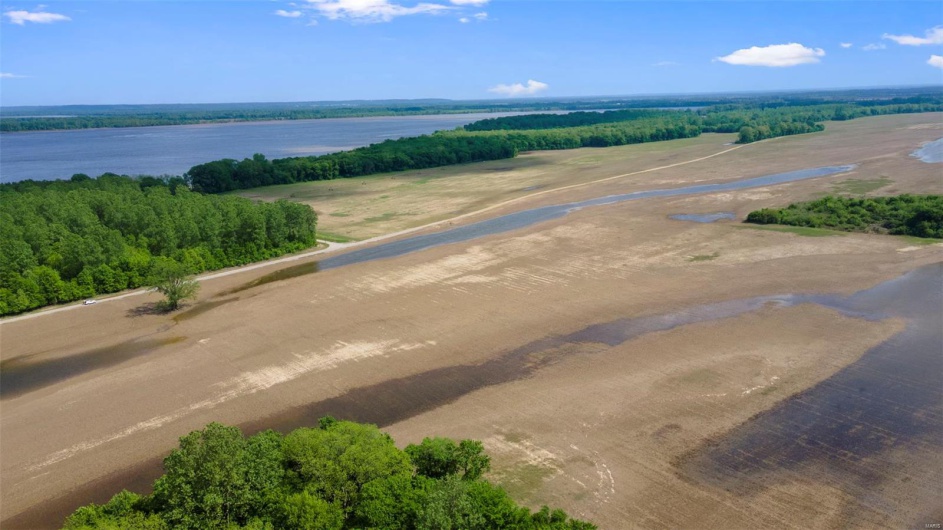 Birds eye view of property with a water view