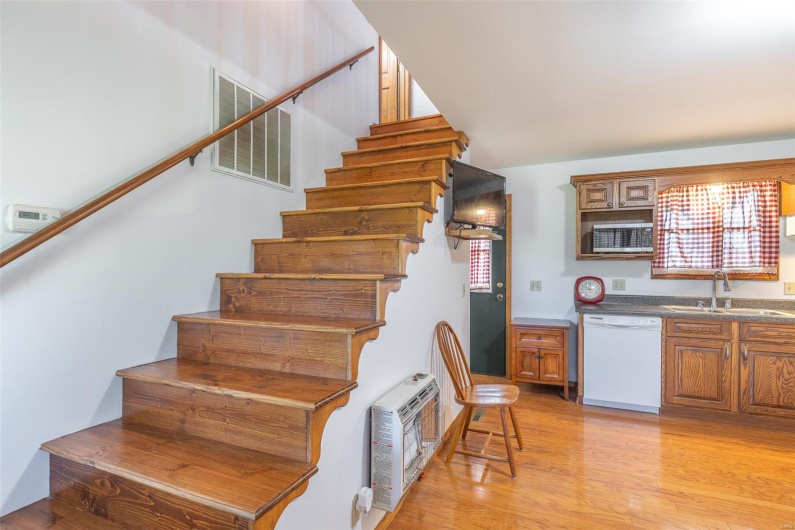Stairs with heating unit and wood finished floors