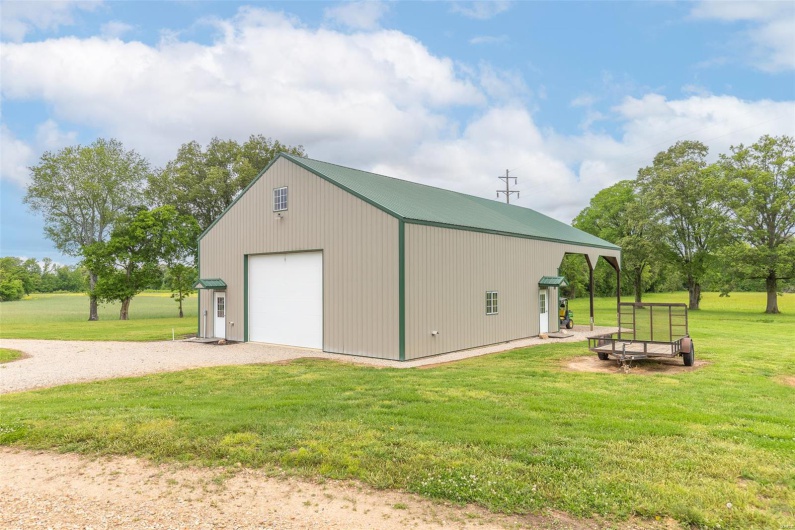 View of outbuilding featuring an outdoor structure and driveway