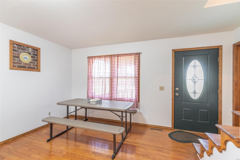 Entrance foyer featuring baseboards and light wood-style floors