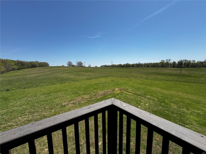 View of yard featuring a balcony and a rural view