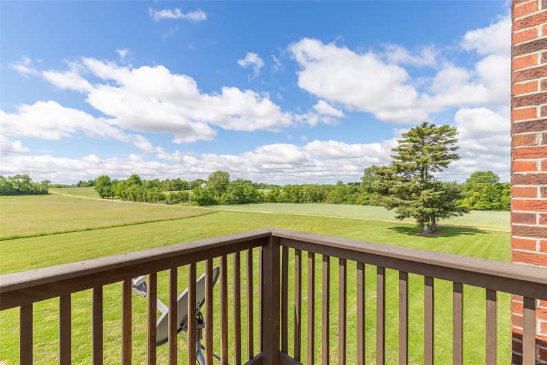 Deck with a rural view and a lawn