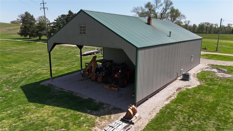 View of pole building with a yard, central air condition unit, and a carport