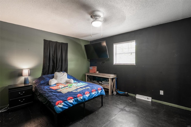 Bedroom with baseboards, a ceiling fan, and a textured ceiling