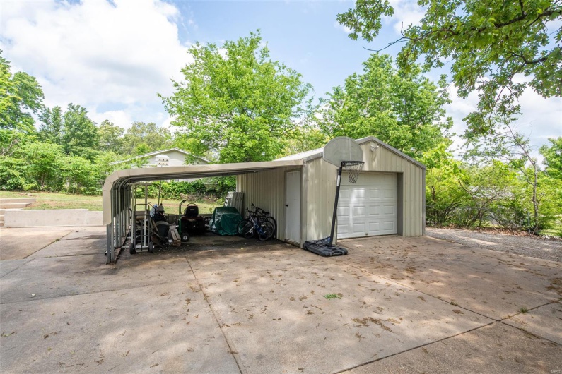 Garage featuring driveway and a garage