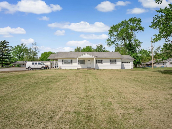 Ranch-style home with an attached garage and a front lawn