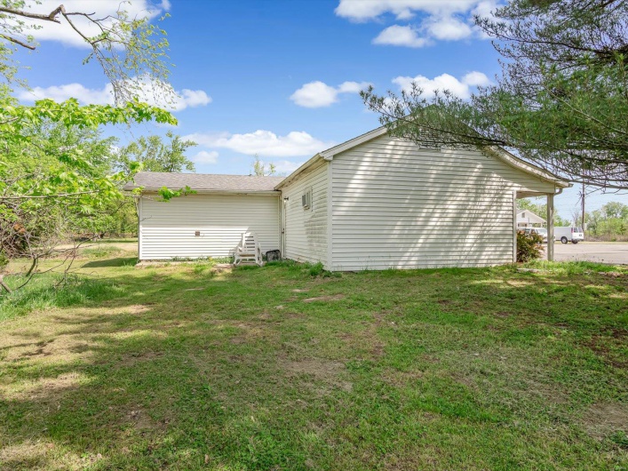 Rear view of property featuring a lawn