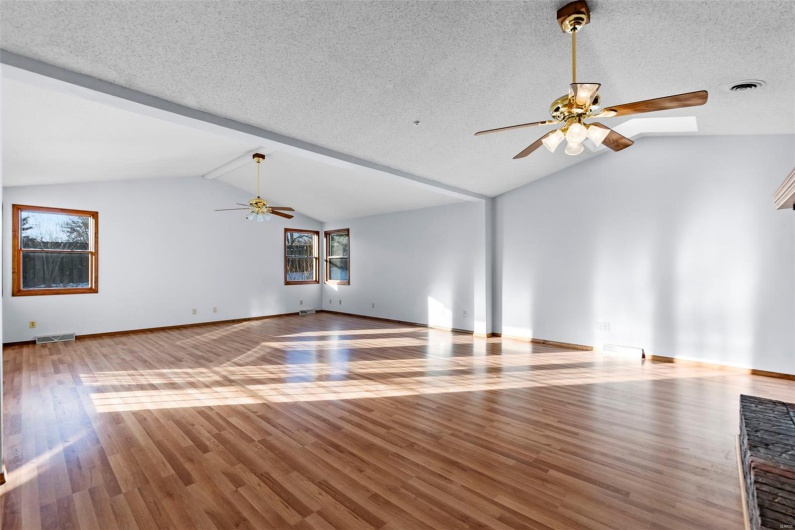 Impressive 600 square foot great room with vaulted ceiling, skylights, and atrium doors