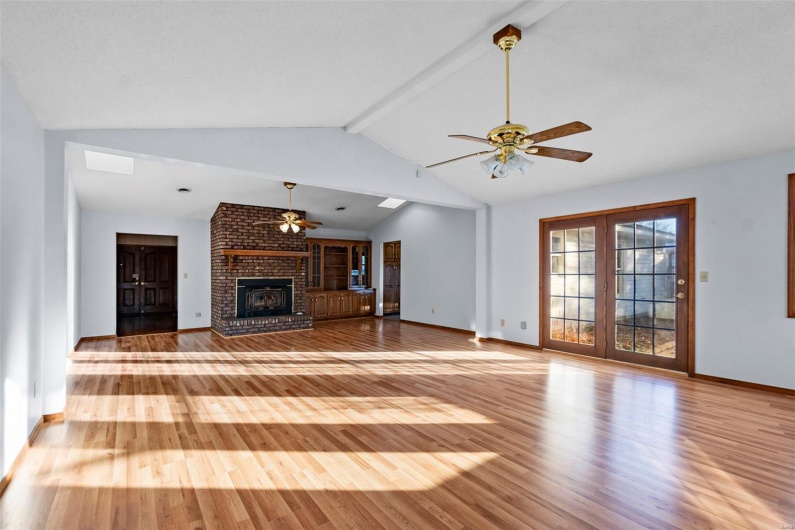 Impressive 600 square foot great room with vaulted ceiling, skylights, and atrium doors