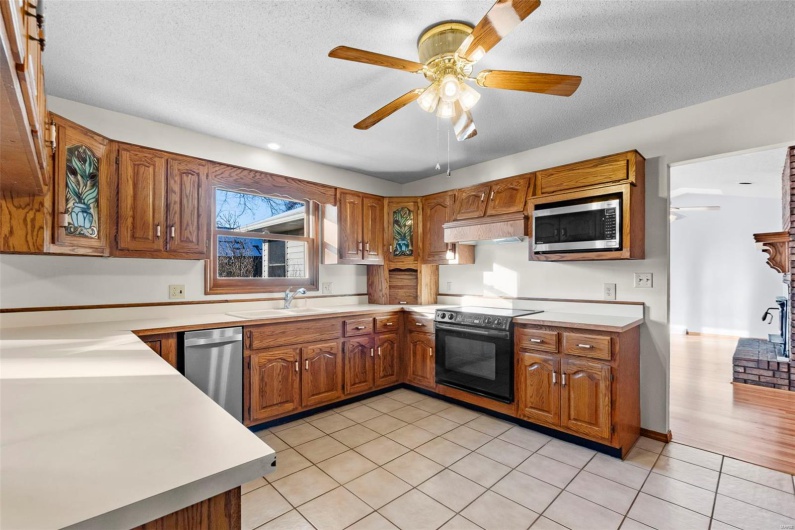 Kitchen features custom cabinetry and built-in ice maker