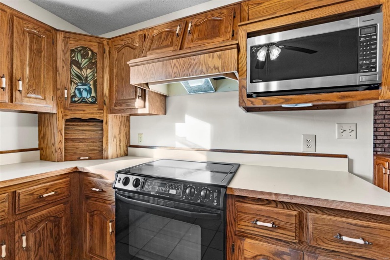 Kitchen features custom cabinetry and built-in ice maker