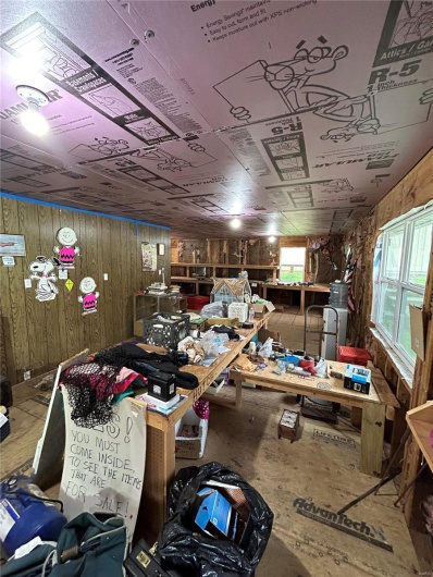 Miscellaneous room with wooden walls and a workshop area