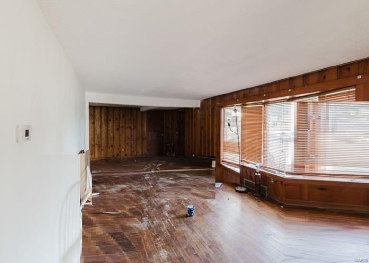 Unfurnished room with wood walls