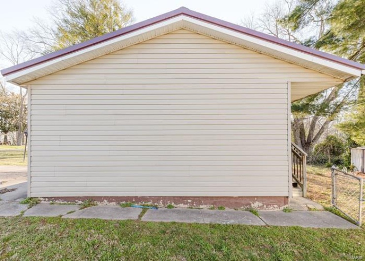 View of home's exterior with fence