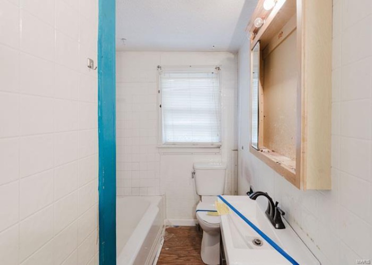 Bathroom featuring toilet and wood finished floors
