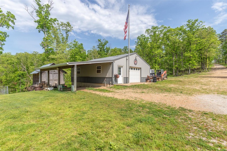 View of outbuilding with an outdoor structure and dirt driveway