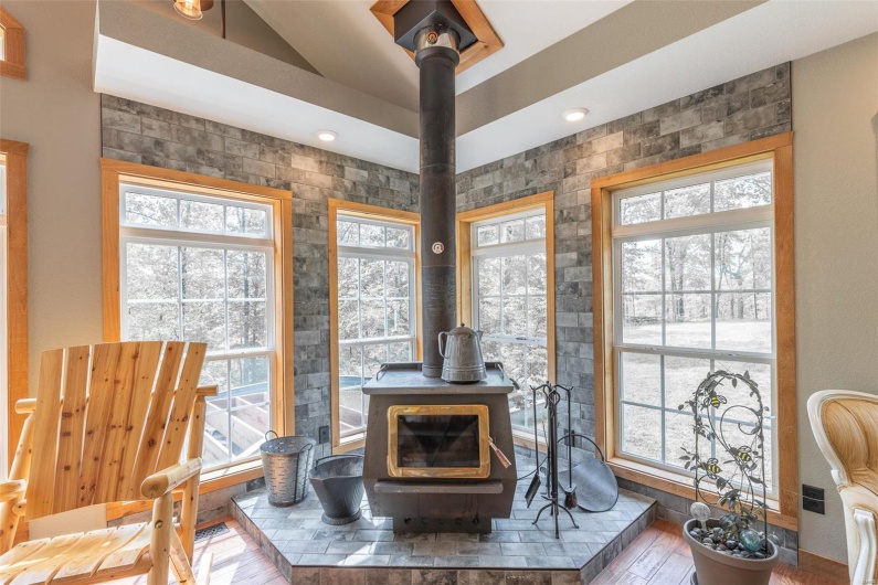 Room details featuring a wood stove and wood finished floors