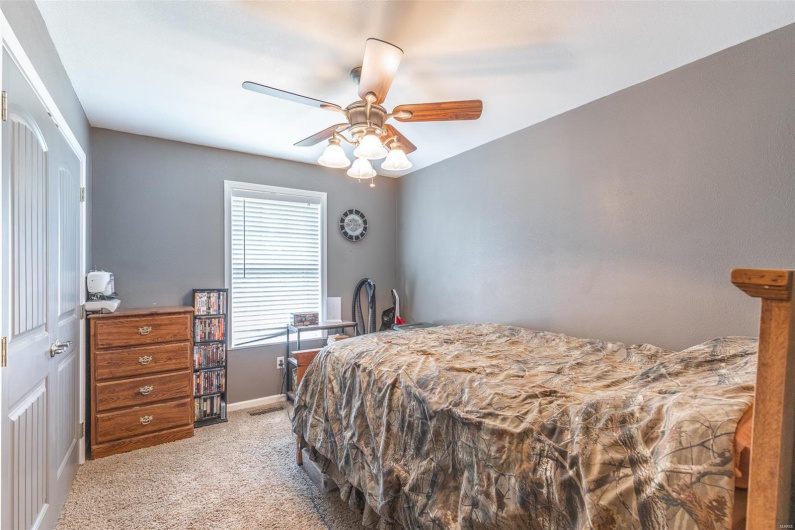 Carpeted bedroom with baseboards and ceiling fan