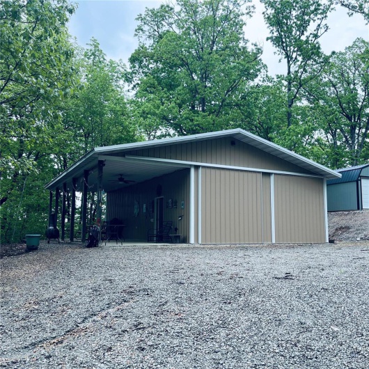 Garage featuring a ceiling fan and a detached garage