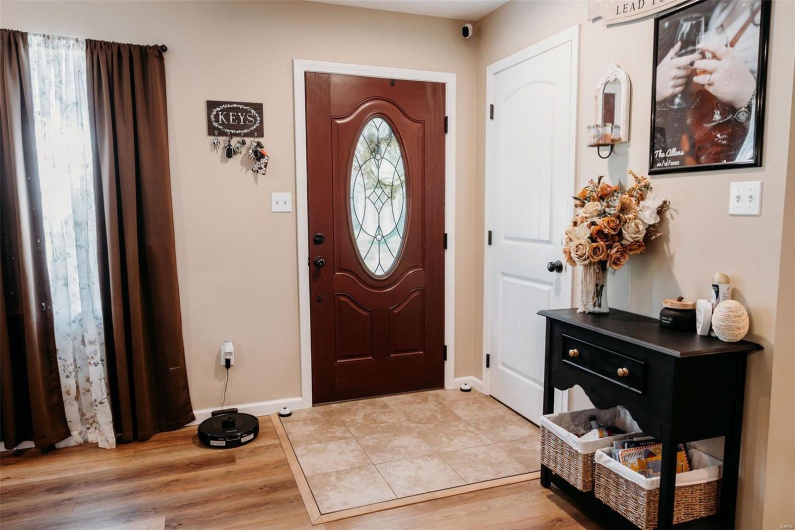 Entrance foyer with baseboards and light wood-style floors