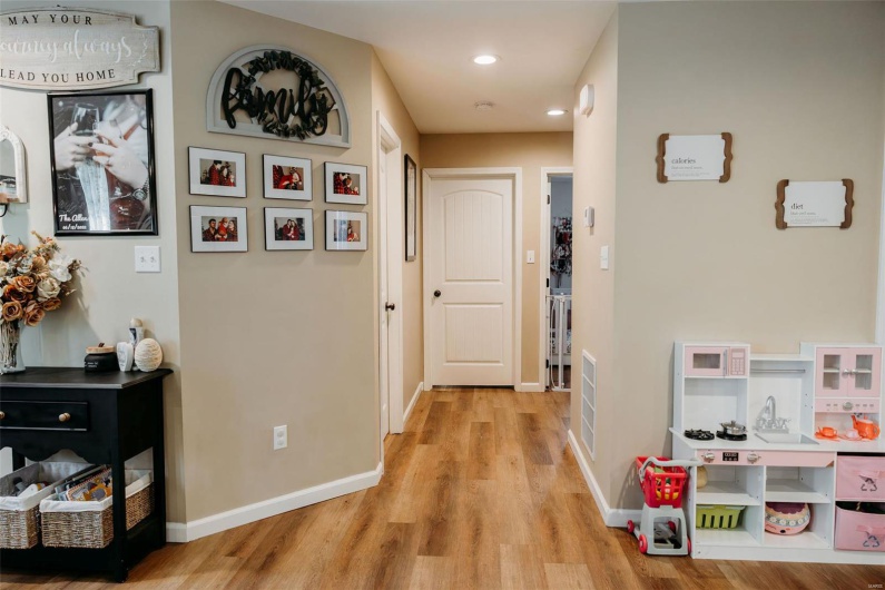 Corridor with recessed lighting, light wood-style floors, and baseboards