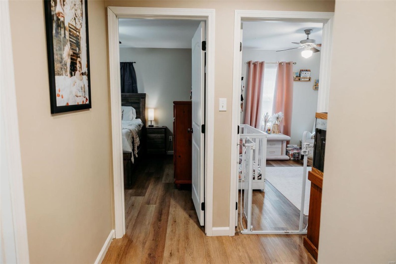 Hall with baseboards and light wood-type flooring