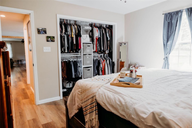 Bedroom with a closet, baseboards, and wood finished floors