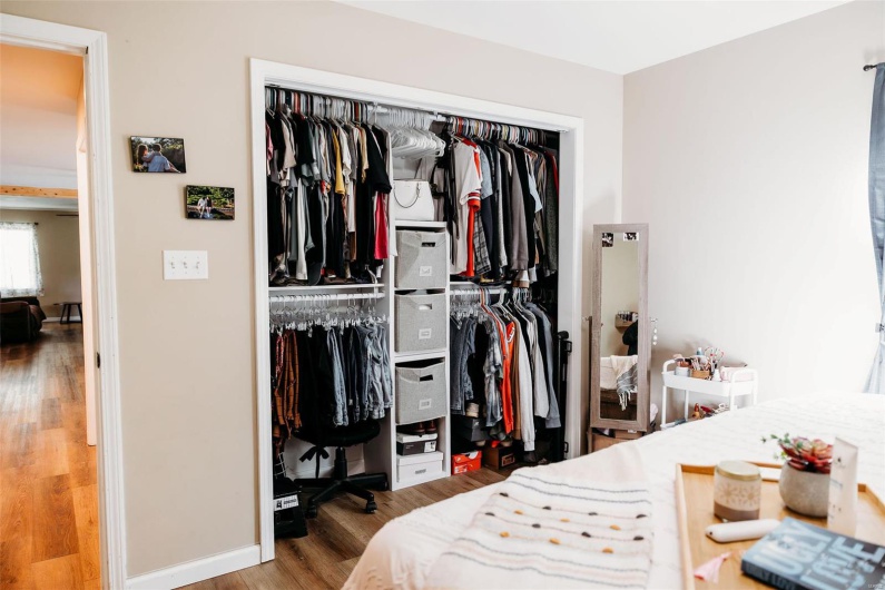 Bedroom with a closet, baseboards, and wood finished floors