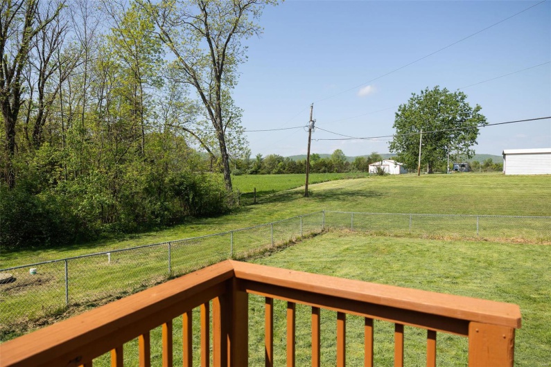 View of yard featuring a rural view and a fenced backyard