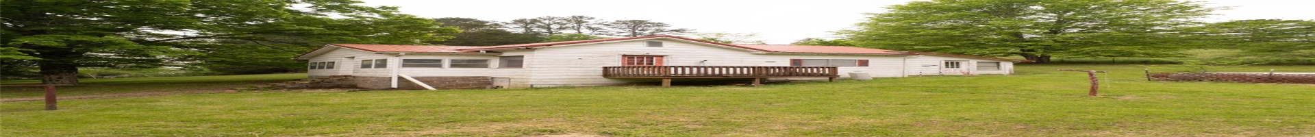 Residential For Sale Rear view of house featuring metal roof and a lawn