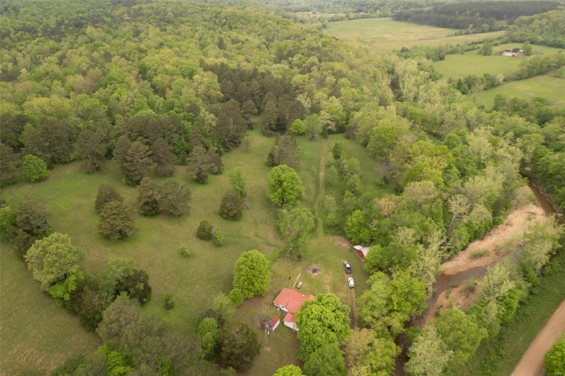 Drone / aerial view featuring a wooded view