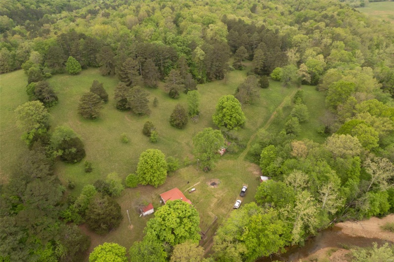 Birds eye view of property with a forest view