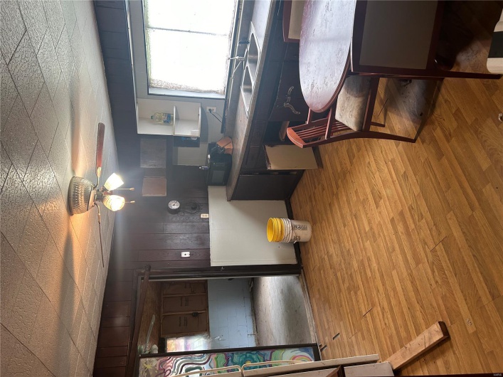 Kitchen with a sink, light wood-style flooring, ceiling fan, and open shelves