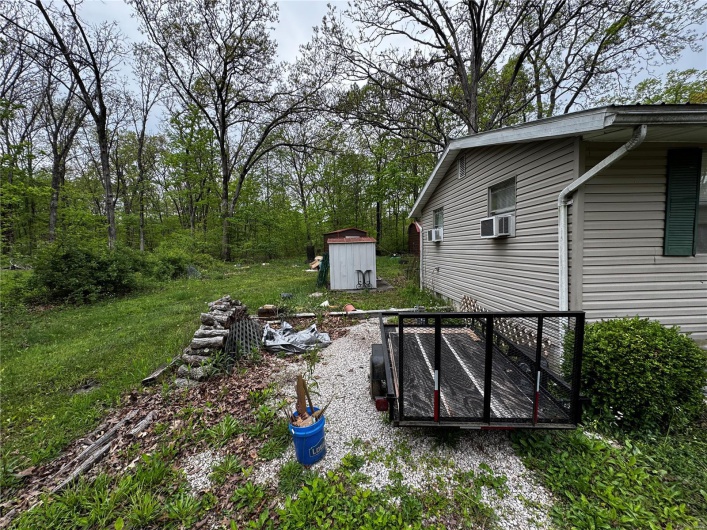 View of yard with an outbuilding and a shed