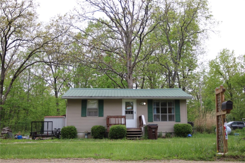 Ranch-style house with a front lawn and metal roof