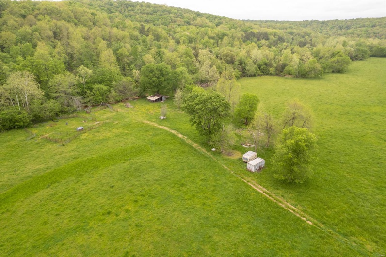 Birds eye view of property with a forest view