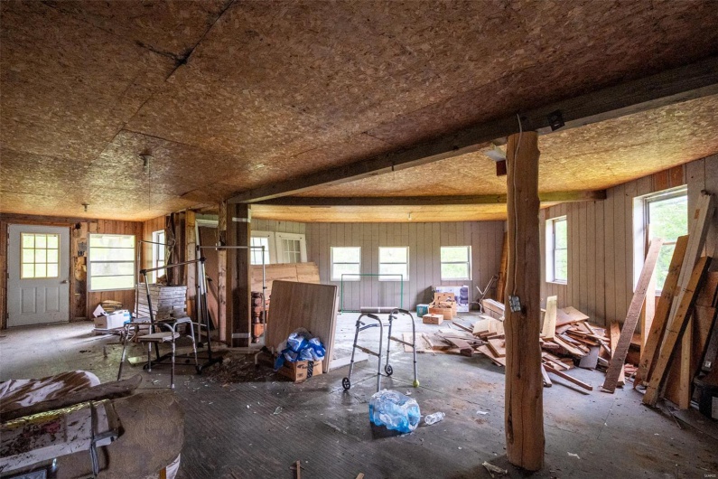 Misc room featuring plenty of natural light and wood walls