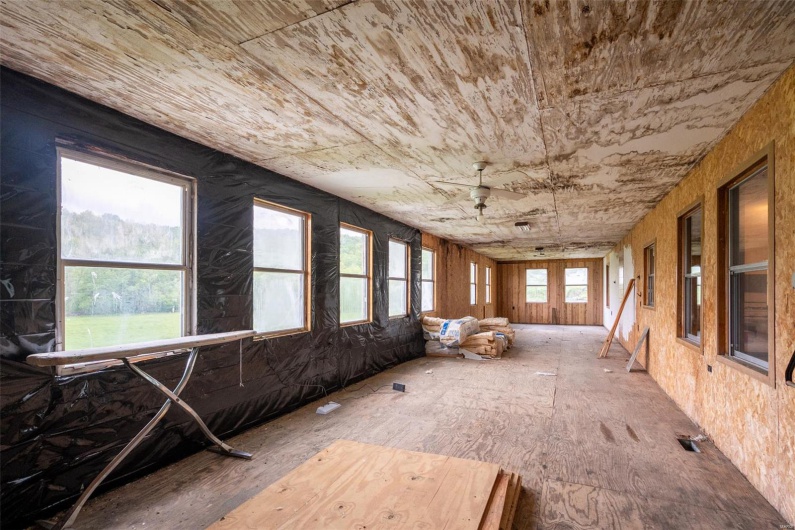 Unfurnished sunroom with wood ceiling
