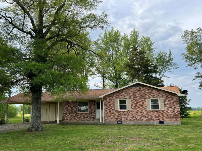 View of front of home featuring a front lawn and brick siding