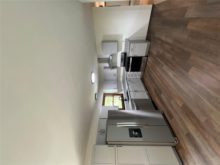 Kitchen featuring fridge, a sink, exhaust hood, dishwashing machine, and stove