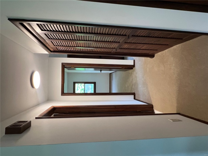 Hall with light carpet and baseboards