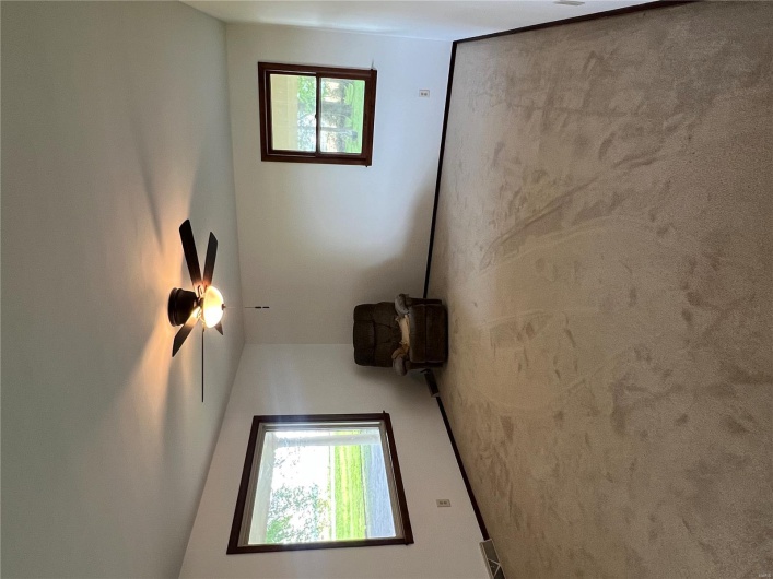 Unfurnished room featuring baseboards, carpet flooring, visible vents, and a ceiling fan