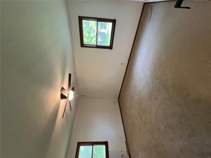 Empty room with a ceiling fan, baseboards, visible vents, and carpet floors