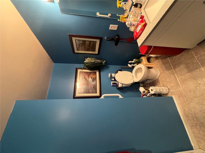Half bath featuring vanity, toilet, and baseboards