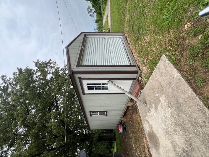 View of outdoor structure with an outbuilding