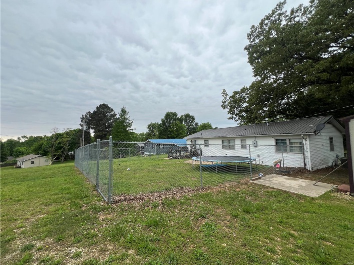 View of yard with a patio and fence