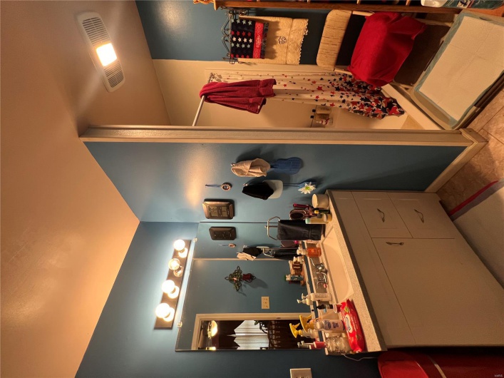 Ensuite bathroom featuring a shower with curtain, visible vents, baseboards, ensuite bath, and vanity