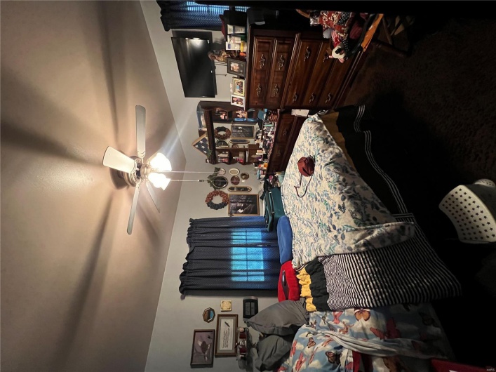Carpeted bedroom with ceiling fan