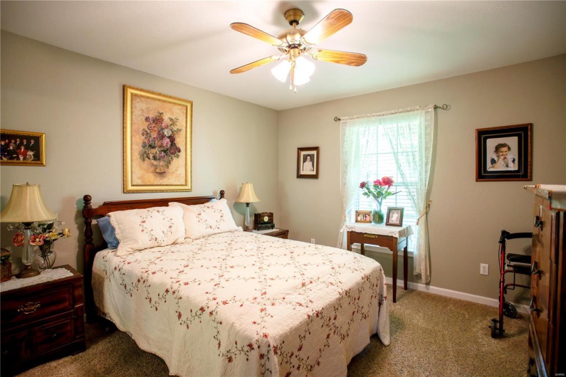 Bedroom featuring ceiling fan, carpet, and baseboards