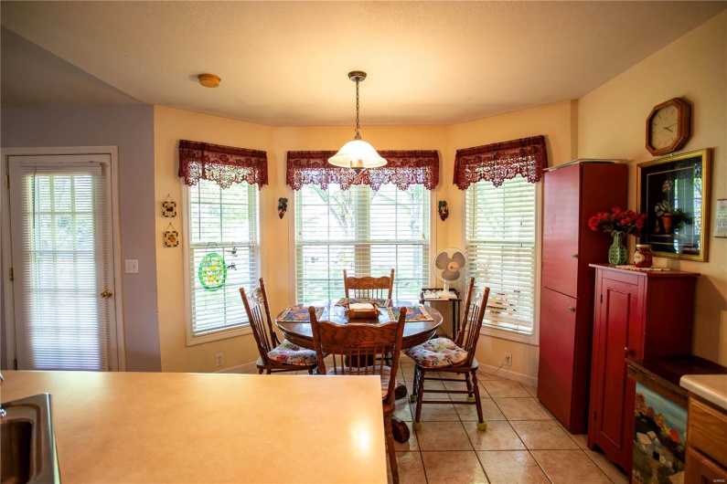 Dining space featuring light tile patterned floors, baseboards, and a healthy amount of sunlight